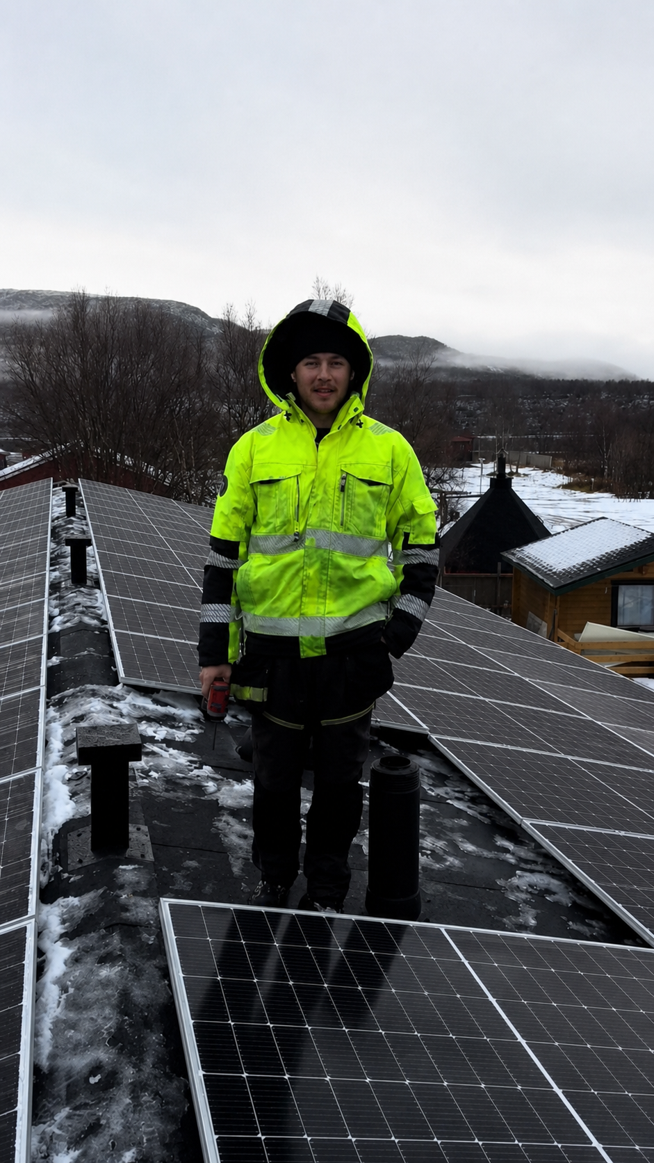 Jami Jokinen on a solar installation roof in Nuorgam, Finland.